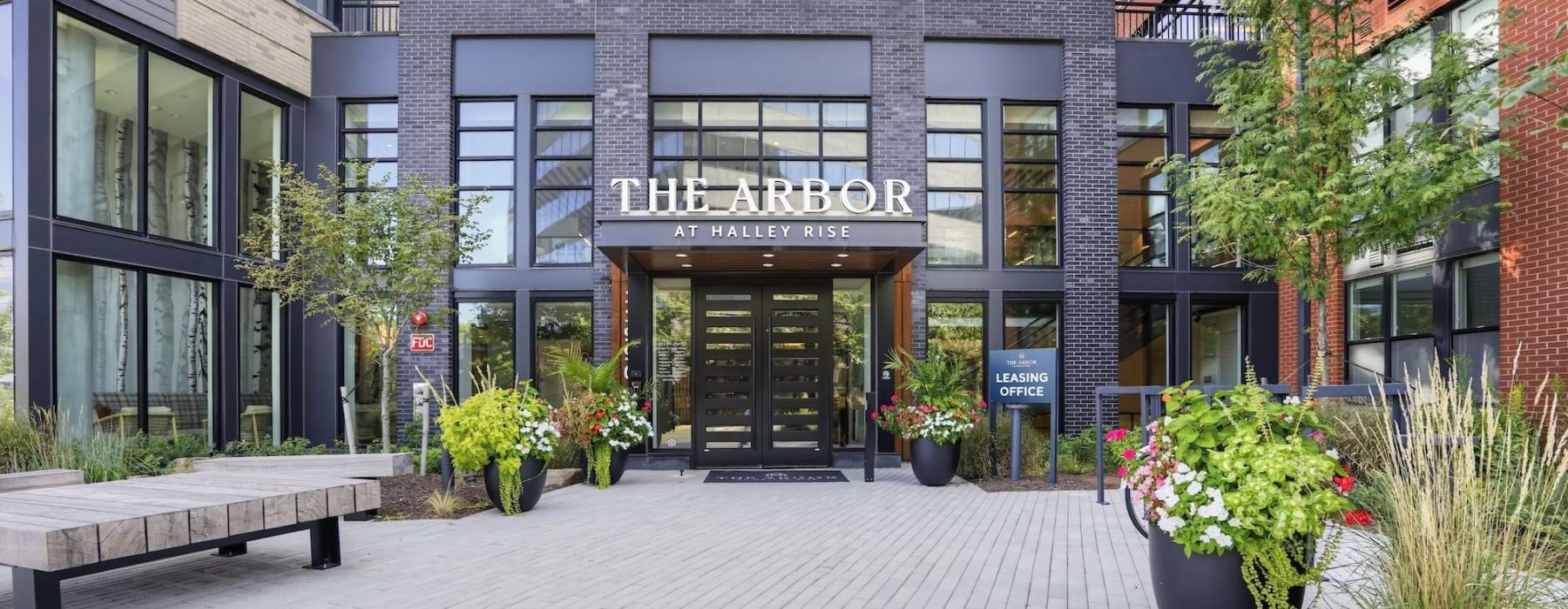 The entrance to a building surrounded by flowers
