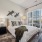 bedroom with bed wall art and large windows