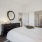 bedroom with bed and mirror on the wall