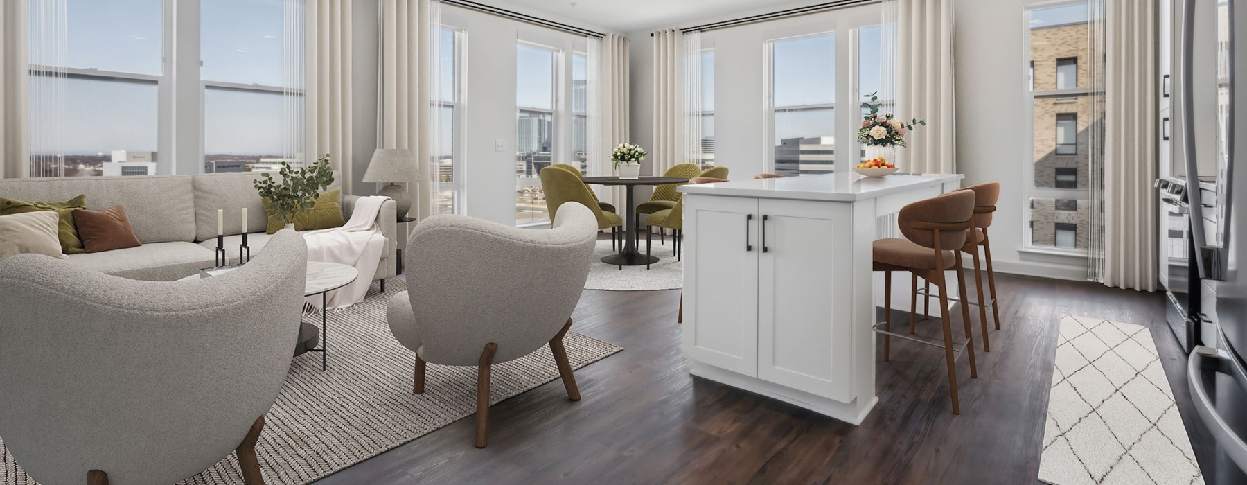 A spacious living area with an open kitchen and dark-colored floors