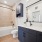 bathroom with bathtub and large mirror