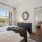 bedroom with bed mirror and large windows