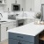 a kitchen with white cabinets